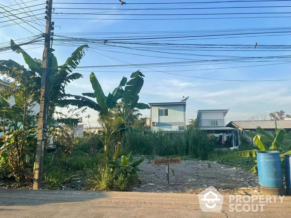 Vacant land with potential for development in a residential area, surrounded by greenery and modern homes.