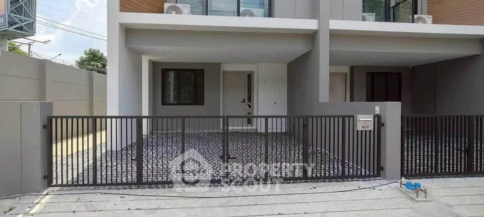 Modern townhouse exterior with gated entrance and sleek design