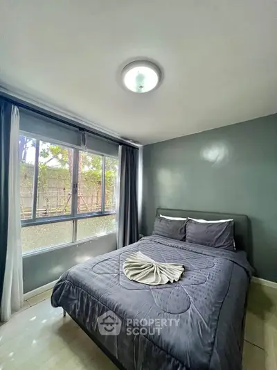 Cozy bedroom with large window and modern decor