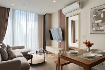 Modern living room with stylish decor and open layout, featuring a cozy sofa and wall-mounted TV.