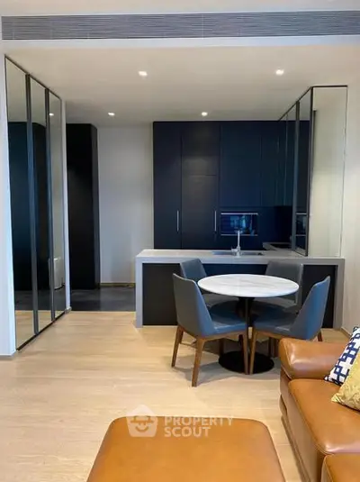 Modern open-plan living room with sleek kitchen and stylish furniture