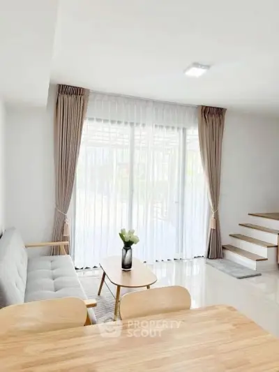 Bright modern living room with large windows and minimalist decor