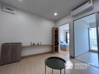 Modern apartment interior with wooden flooring and air conditioning, featuring a cozy bedroom and balcony view.