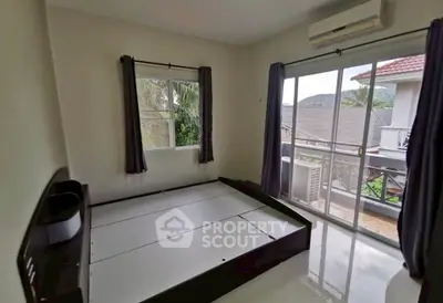 Spacious bedroom with large windows and balcony access in modern home