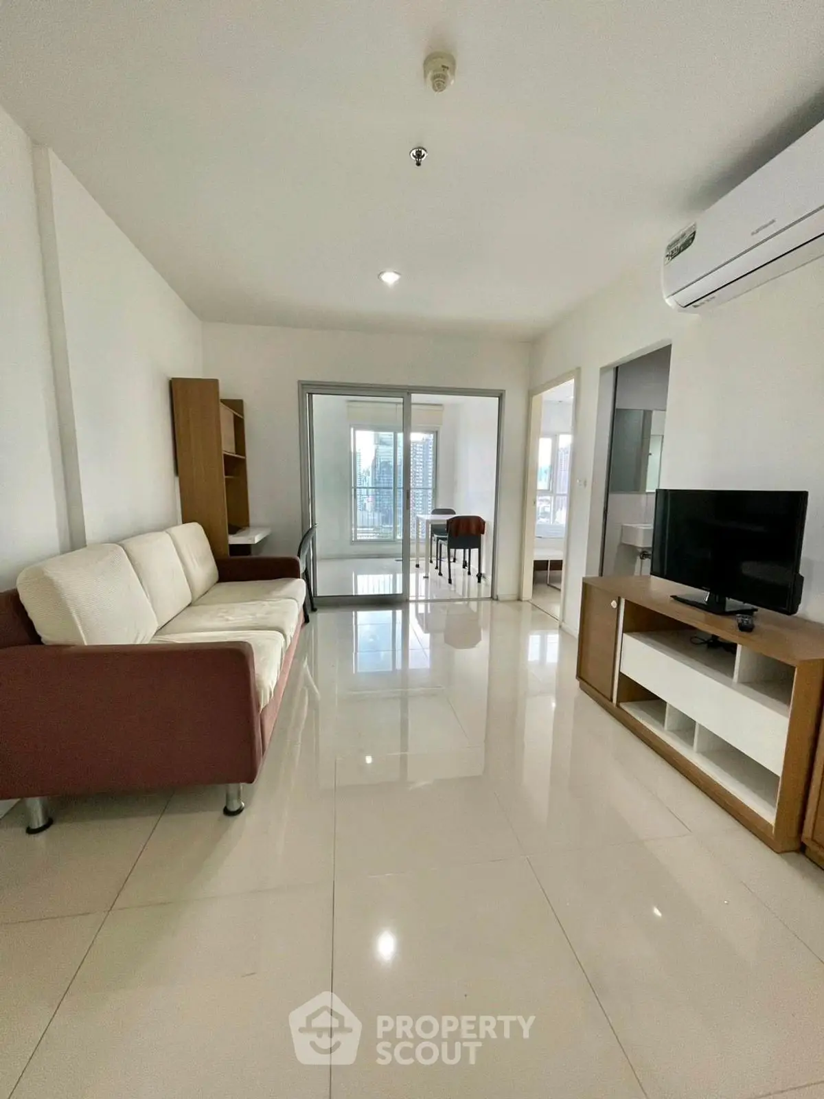 Spacious modern living room with sleek furniture and large windows for natural light.