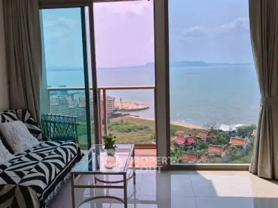 Stunning ocean view from modern living room with floor-to-ceiling windows and chic decor.