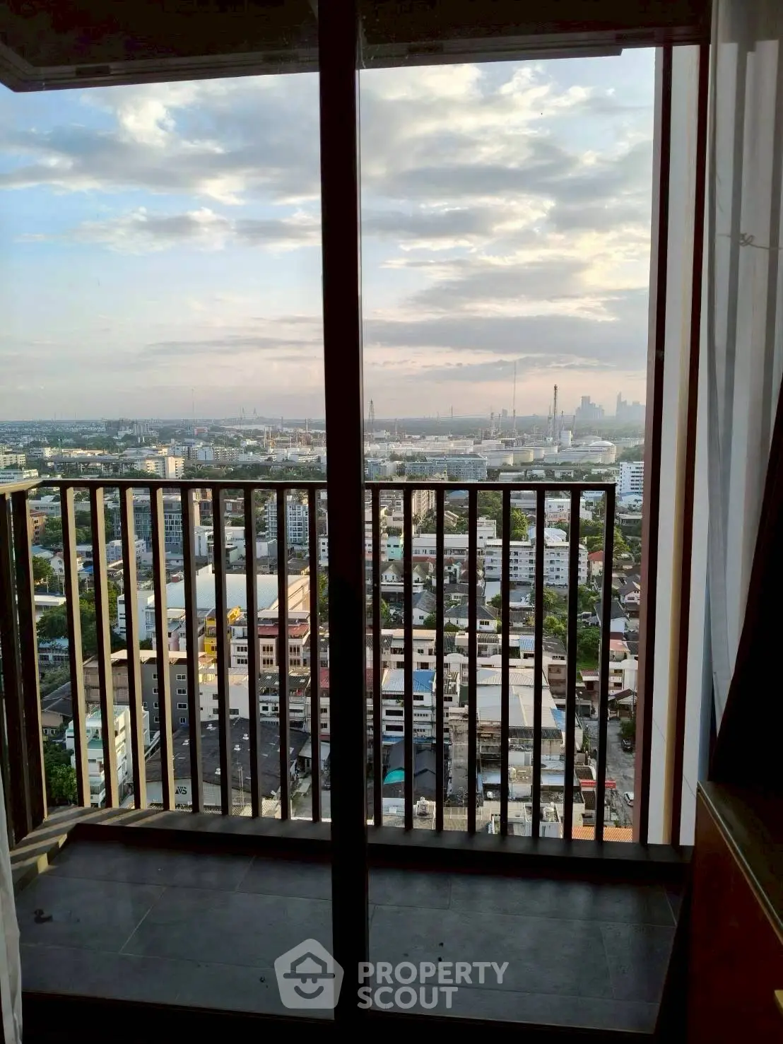 Stunning cityscape view from a high-rise balcony with expansive skyline.