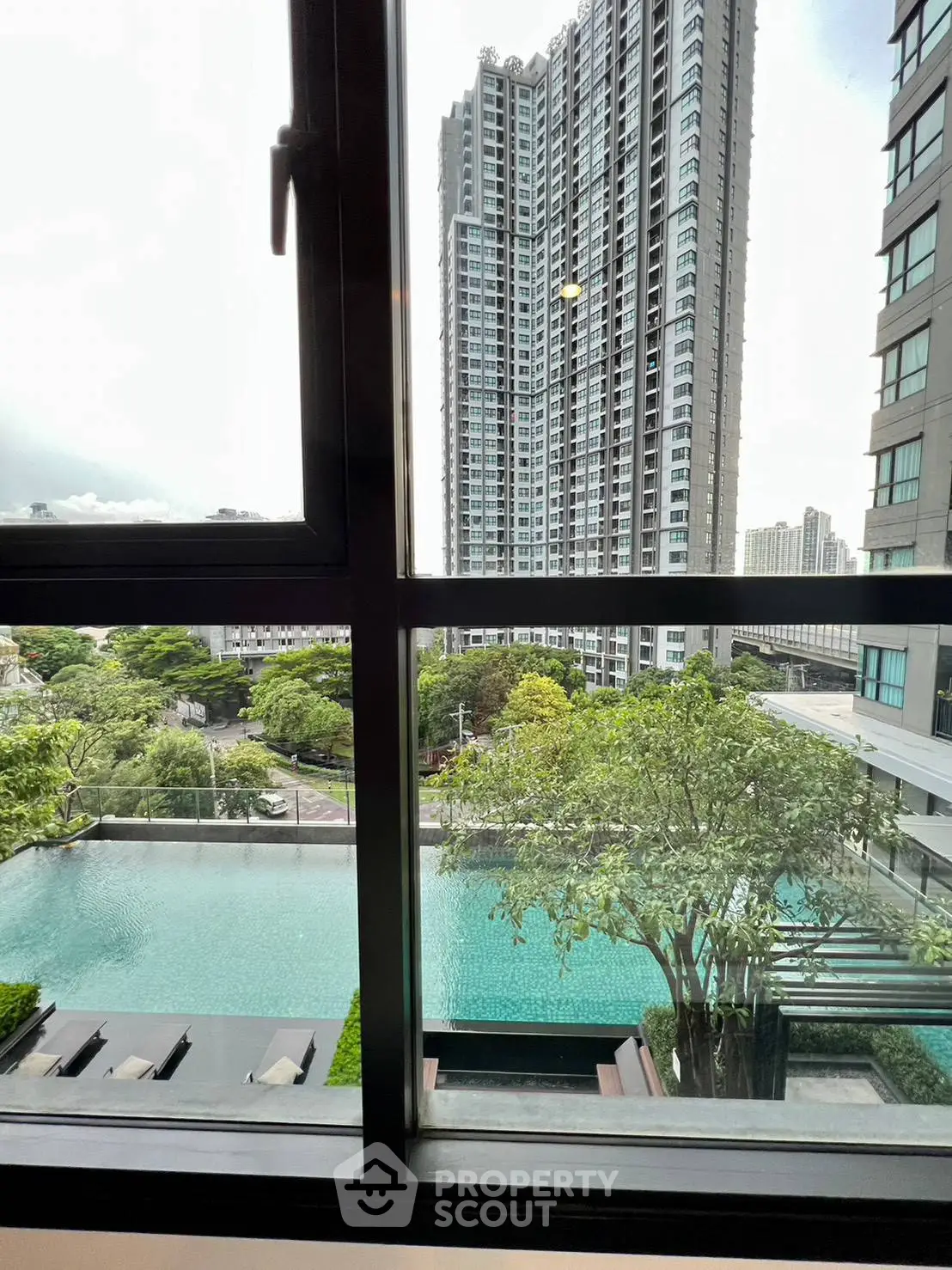 Luxurious high-rise apartment with stunning pool view and modern cityscape.