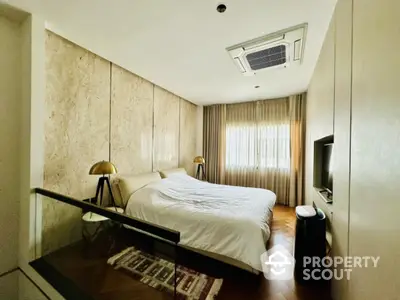 Luxurious bedroom with modern decor and natural light, featuring a cozy bed and stylish lighting.