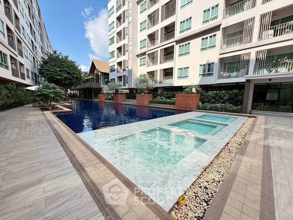 Luxurious condominium with stunning pool and modern architecture, perfect for urban living.