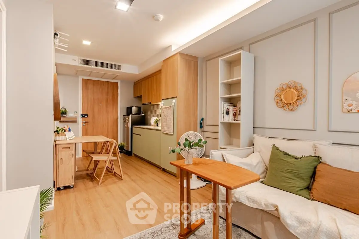 Charming modern living room with open kitchen, stylish decor, and cozy seating area, perfect for urban living.