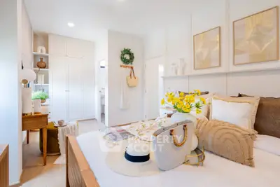 Bright and cozy bedroom with elegant decor and ample natural light.