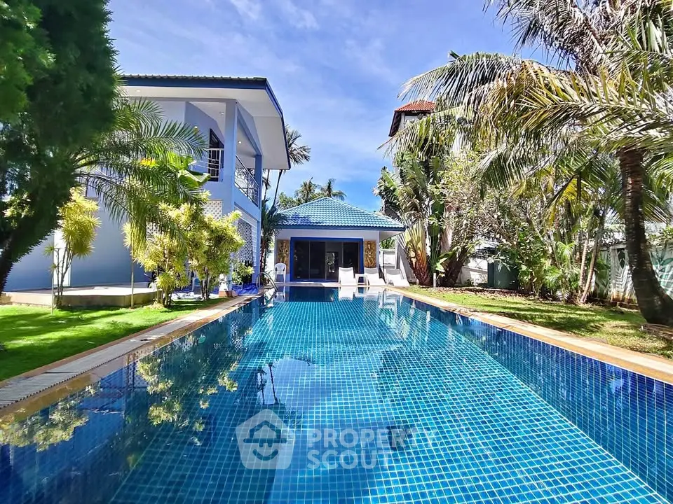 Luxurious villa with stunning pool and lush garden, perfect for tropical living.