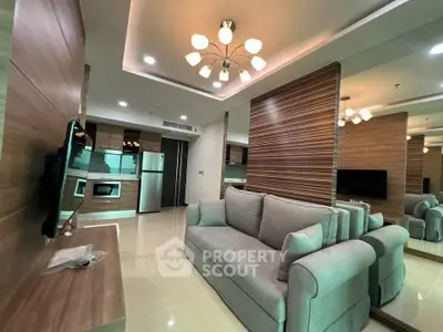 Modern living room with stylish lighting and open kitchen layout in a contemporary apartment.