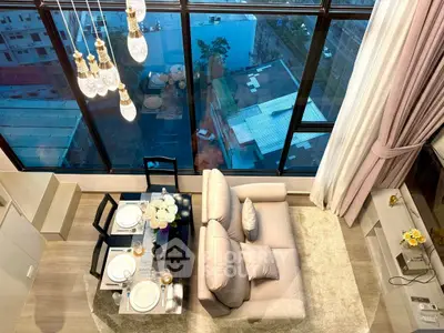 Luxurious high-rise living room with floor-to-ceiling windows and elegant dining area.