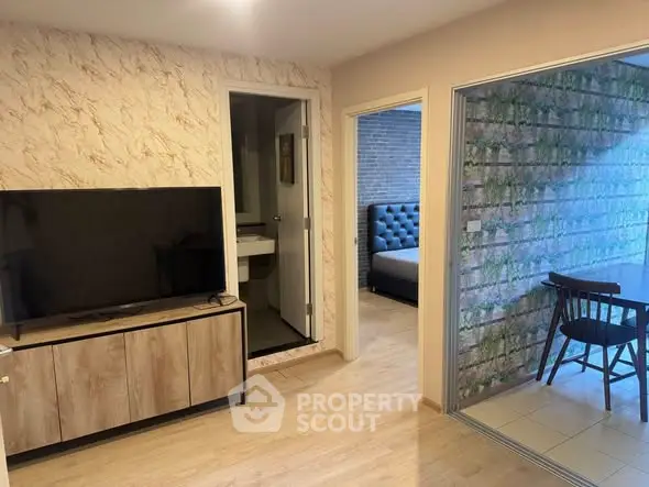 Modern apartment interior with TV, bedroom, and dining area