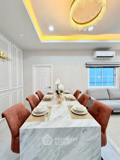 Elegant dining area with modern chandelier and stylish decor in a contemporary home.