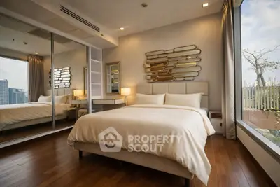 Luxurious bedroom with floor-to-ceiling windows and city view, featuring elegant decor and mirrored closet.