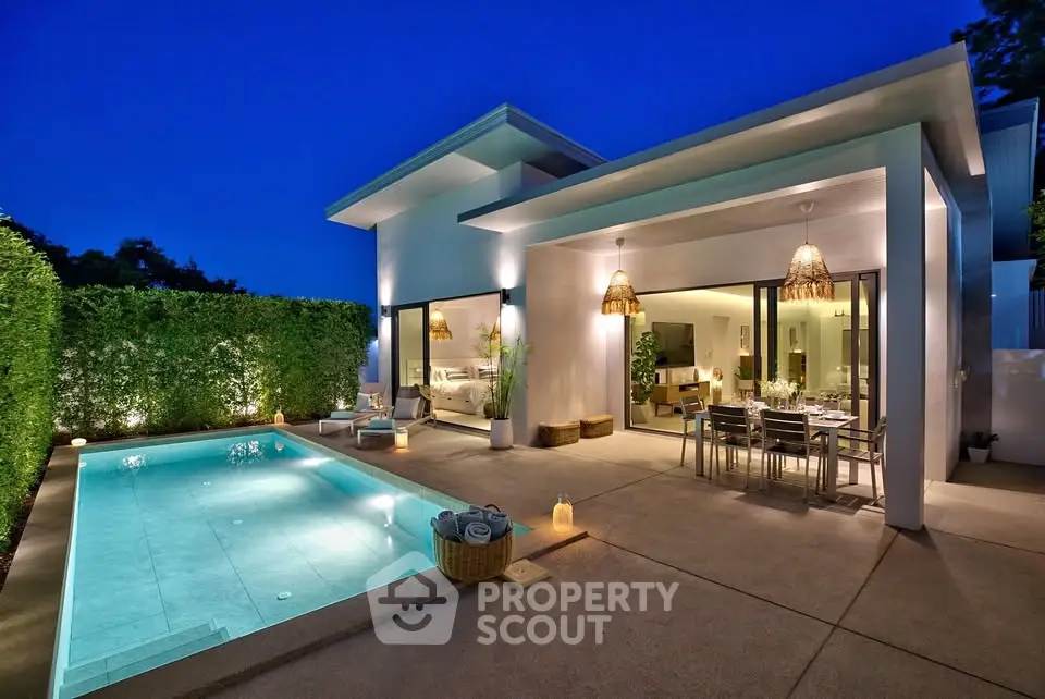 Luxurious modern villa with private pool and elegant outdoor dining area at dusk.