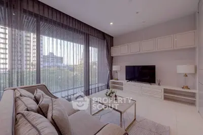 Spacious modern living room with large windows and elegant decor in a high-rise apartment.
