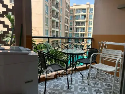 Charming balcony with pool view, stylish seating, and tiled floor in modern apartment complex.