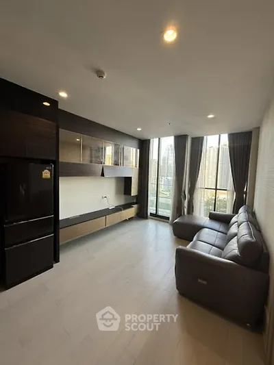 Modern living room with city view, sleek furniture, and large windows.