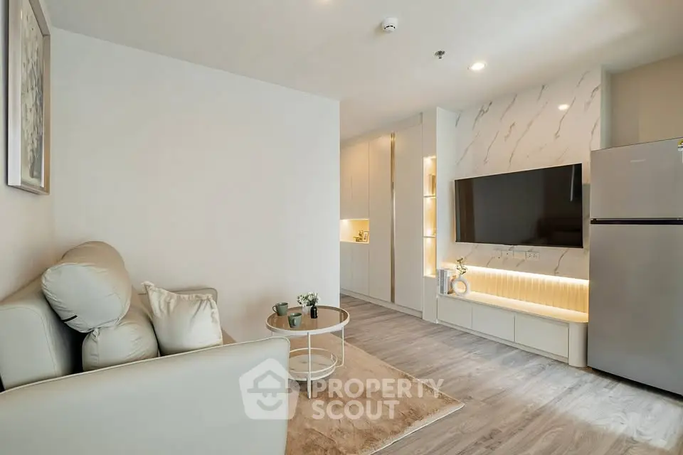 Modern living room with sleek design, featuring a cozy sofa, stylish TV setup, and elegant lighting.