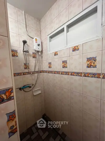 Charming bathroom with unique tile design and modern shower setup