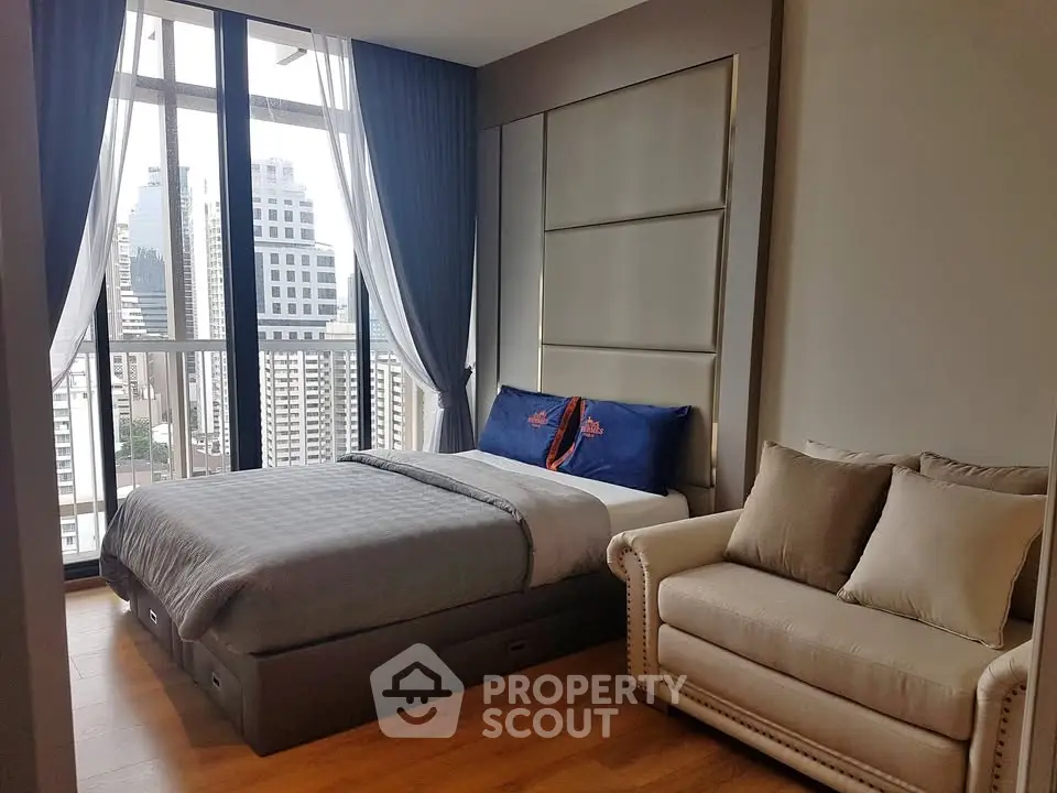 Modern bedroom with city view, featuring a cozy bed and elegant sofa, perfect for urban living.