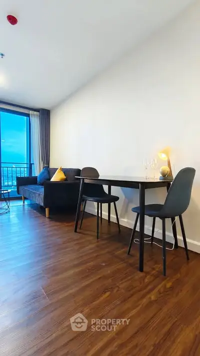Modern living room with sleek furniture and stunning city view, perfect for urban living.