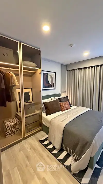 Modern bedroom with stylish decor and built-in wardrobe, perfect for cozy living.