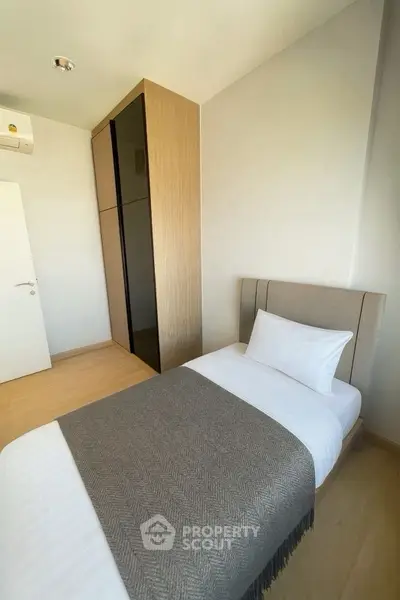 Cozy minimalist bedroom with single bed and modern wardrobe