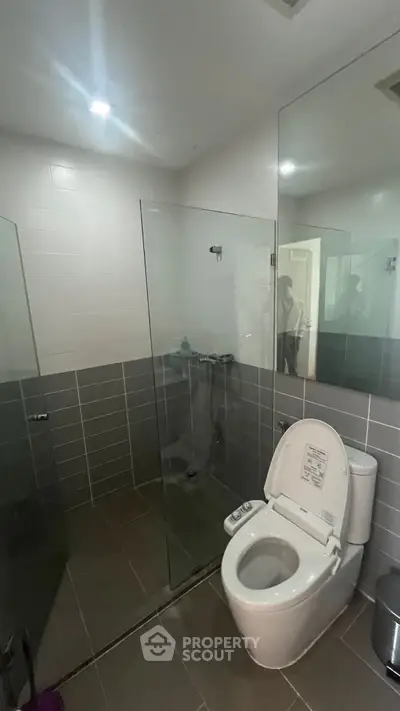 Modern bathroom with glass shower and sleek toilet design