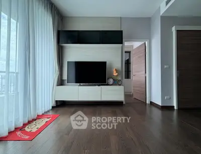 Modern living room with sleek TV unit and wooden flooring