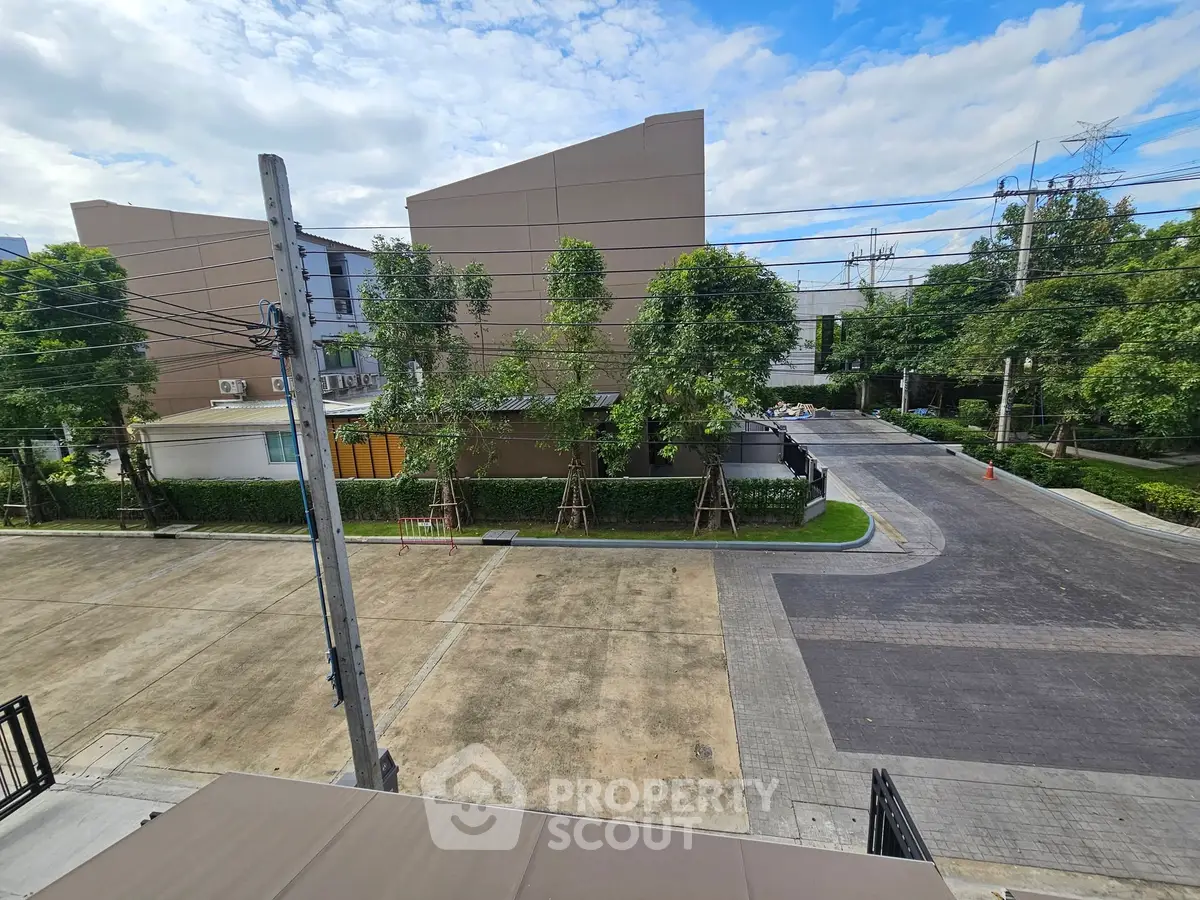 Spacious residential area with modern buildings and lush greenery, perfect for serene living.