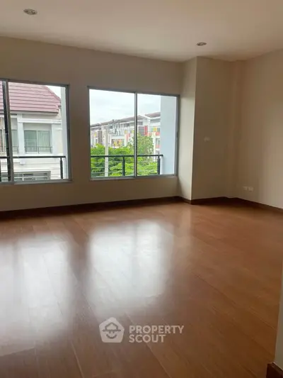 Spacious empty room with large windows offering a bright and airy atmosphere, perfect for customization.