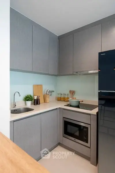 Modern kitchen with sleek cabinetry and built-in appliances