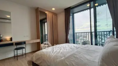 Spacious bedroom with stunning city view and modern furnishings