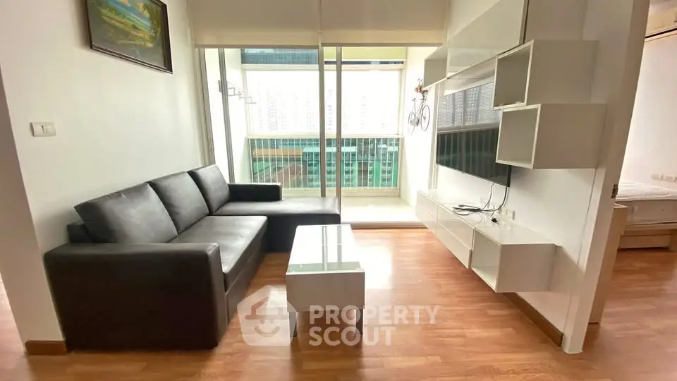 Modern living room with sleek furniture and balcony view in urban apartment