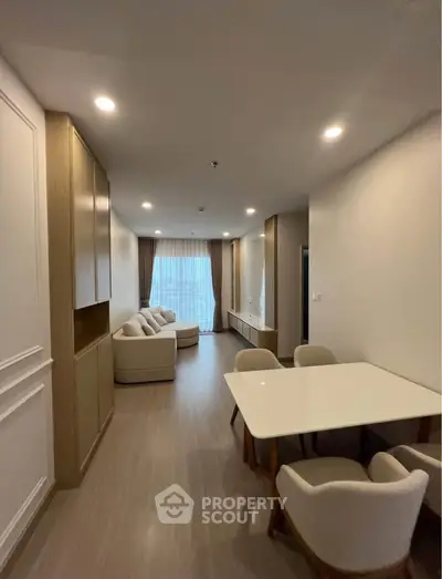 Spacious modern living room with elegant dining area and cozy seating, perfect for relaxation and entertainment.