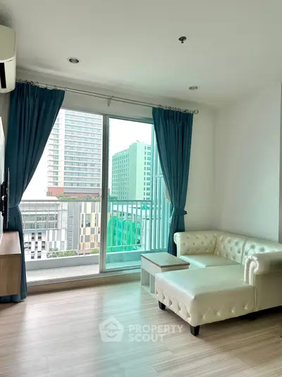 Modern living room with white leather sofa and city view balcony.