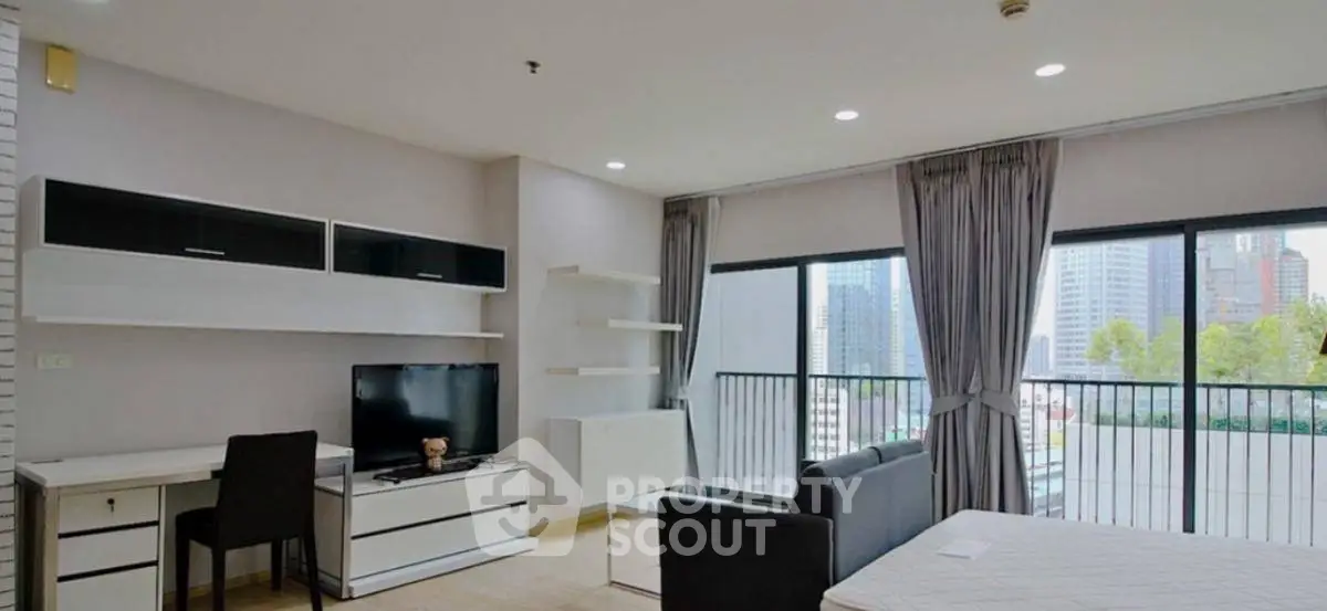 Modern living room with city view and sleek furniture in high-rise apartment
