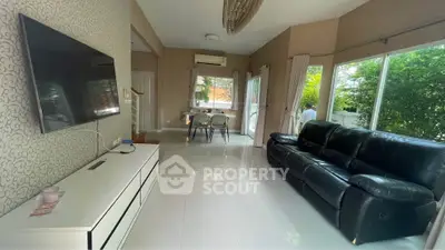 Spacious living room with modern decor and large windows for natural light.