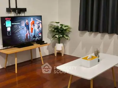 Modern living room with sleek TV setup and stylish wooden furniture