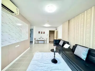 Spacious living room with modern decor and elegant wallpaper