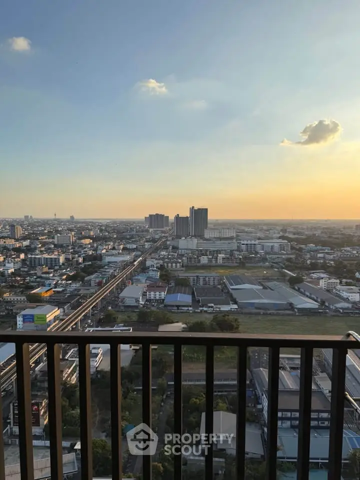 Stunning cityscape view from high-rise balcony at sunset