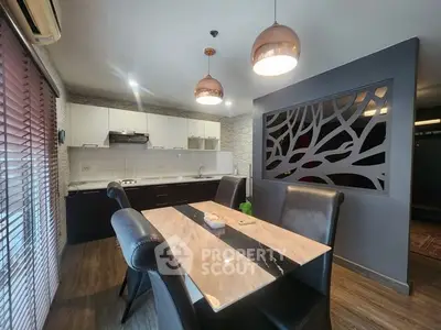 Modern kitchen with elegant dining area and stylish lighting