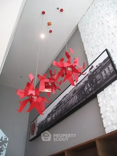 Modern interior with unique red chandeliers and artistic wall decor