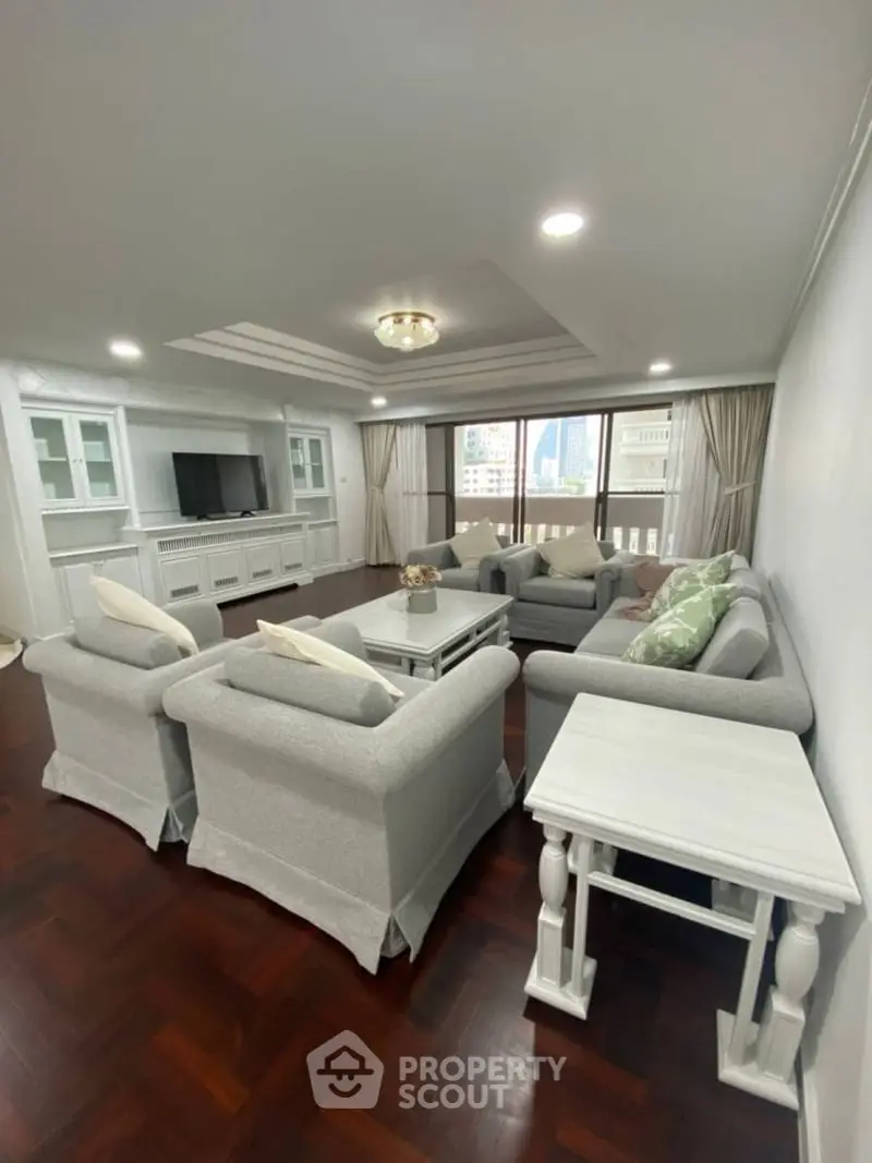 Spacious living room with elegant furniture and city view, perfect for relaxation and entertainment.