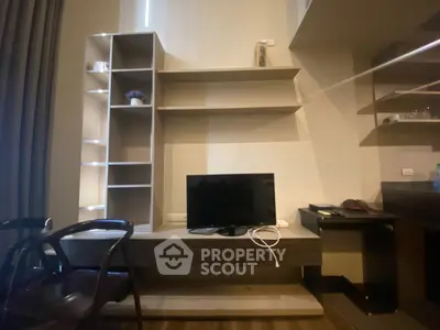 Modern living room with sleek shelving and flat-screen TV, perfect for urban living.